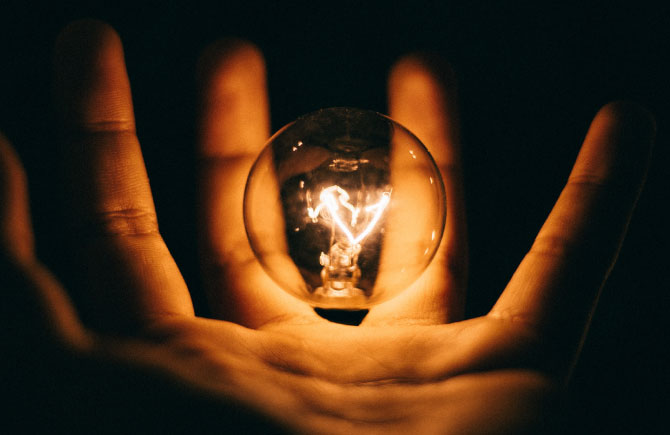Light bulb in a hand. Photo: Unsplash.
